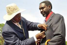 James Akena receives a medal from President<br />Museveni in 2010 on behalf of his late father,<br />former President Milton Obote: