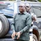 The Kampala District Land Board Chairperson, in chains being led to the courts of law. <br />This is a self made scum made by the NRM government. District employees are busy dealing in real business of all types in the country. Unfortunately many of these NRM die hard who have taken on such responsibilities have found themselves on a different side of the law.