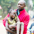 A KCCA law enforcement official lifts up a rescued street kid that begs in Kampala capital city.<br />It is unfortunate indeed that these children have been separated from their dear parents and thrown into government camps.<br />And the government is bent on taking these parents to the courts of law because of their poverty to be sentenced to a punishment of imprisonment of over 3 months!<br />What sort of a socialist African government is this. You can never hear of such inhuman deeds done by even the capitalists or communists of this world. Where to be very poor is a crime and to go on the public streets to beg with your family, is to break the law of this poor African country of Uganda!