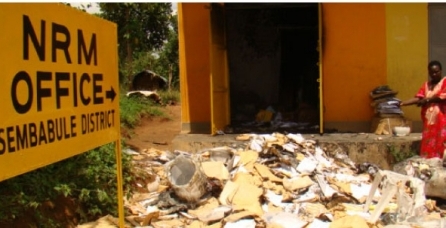 A woman looks at burnt files at the NRM office in